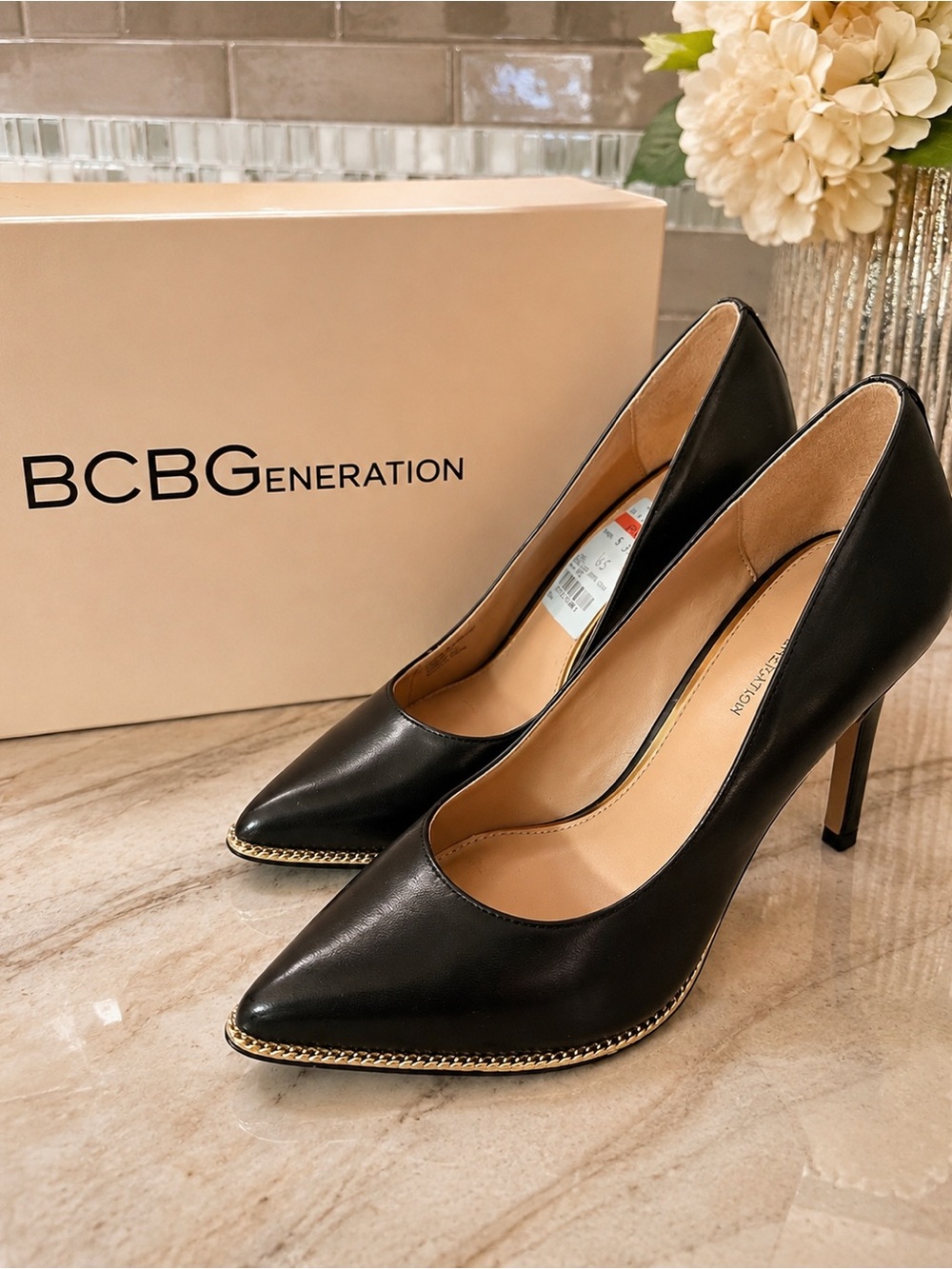 BCBGeneration Black Pointed Toe Pumps with Gold Chain Trim